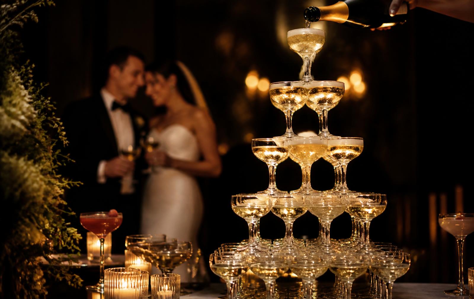 Champagne coupe tower at a candlelit wedding reception